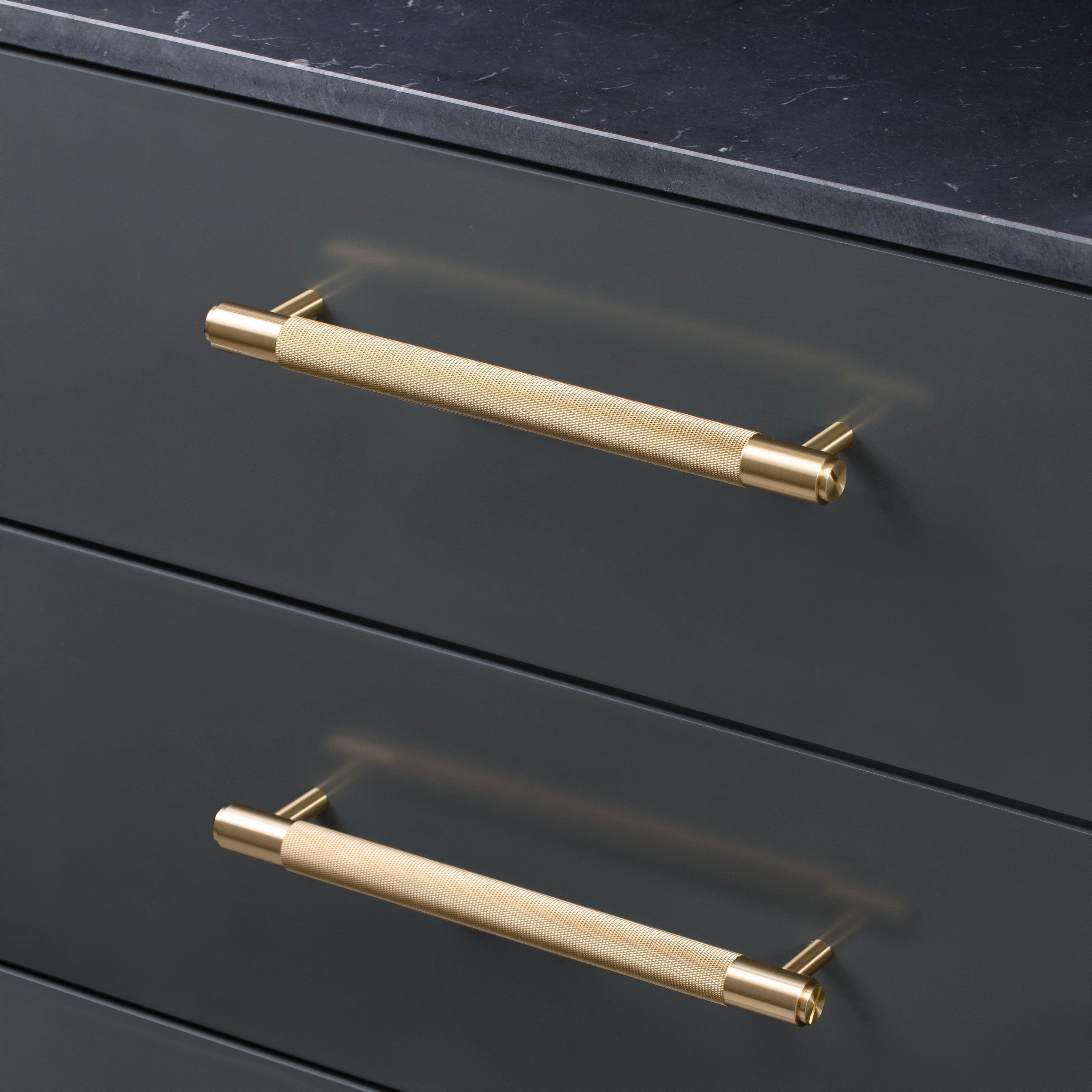 Picture of cabinet drawers with cross pull bars in brass