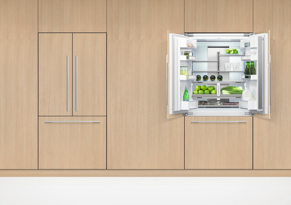 Modern Fisher & Paykel refrigerator with open door displaying interior contents against a wooden wall.