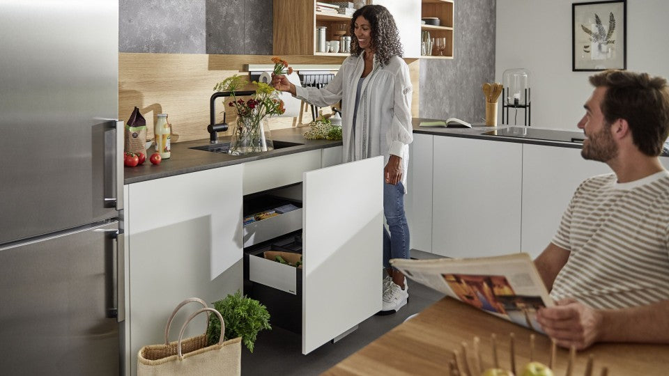 White kitchen with a couple looking at flowers