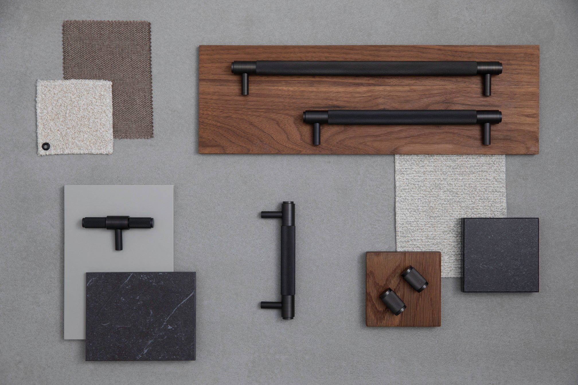 Collection of Buster & Punch cabinet hardware - handles and knobs - on a gray background