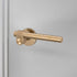 Buster + Punch Cast sprung door handle set in brass – view 1